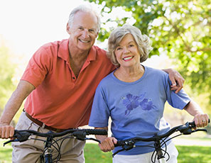 Photo of a man and woman on bicycles. Link to Life Stage Gift Planner Ages 60-70 Situations.